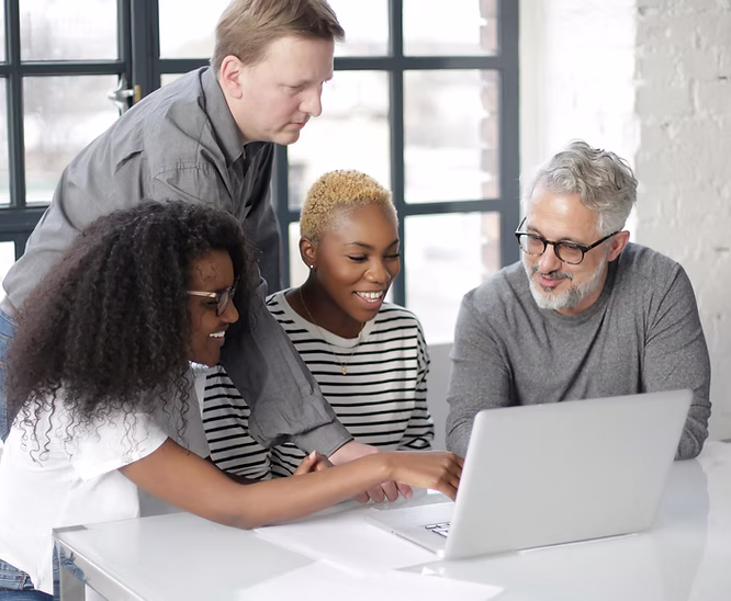 image of people reviewing data on a computer